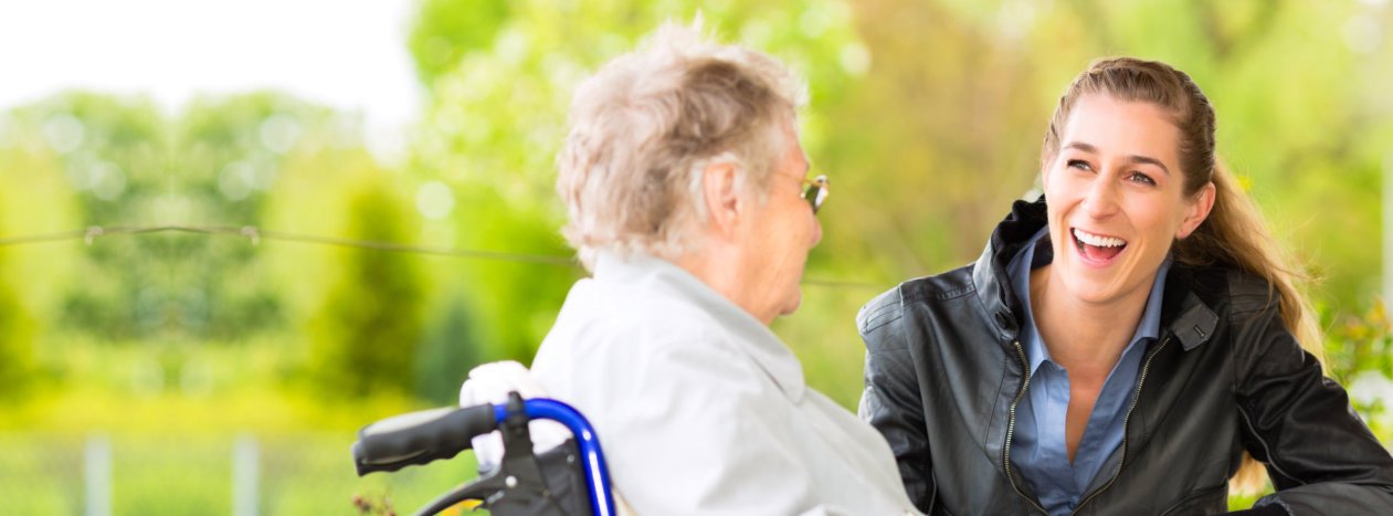 Old woman is talking with her caregiver